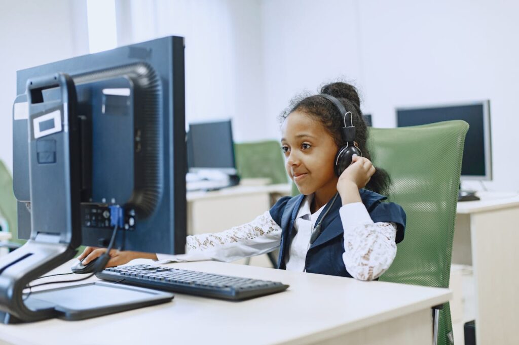 A Girl Wearing Headset While Using a Computer 